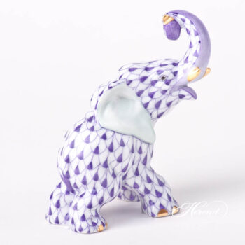 Elephant figurine is painted in Vieux Herend (VHL) Lilac fish scale design. This fishnet or fish scale pattern is a typical motif of Herend. It can be ordered in 14 different VH (fishnet/fish scale) colors. Zoological description: Touching is an important form of communication among elephants. Individuals greet each other by stroking or wrapping their trunks; the latter also occurs during mild competition. The older elephants use trunk-slaps, kicks and shoes to discipline younger ones. Touching is especially important for mother–calf communication. Figurine data Height: 8.5 cm (3.5"H) Width: 4.7 cm (2"W) Length: 8 cm (3.25"L) Weight: 0.09 kg